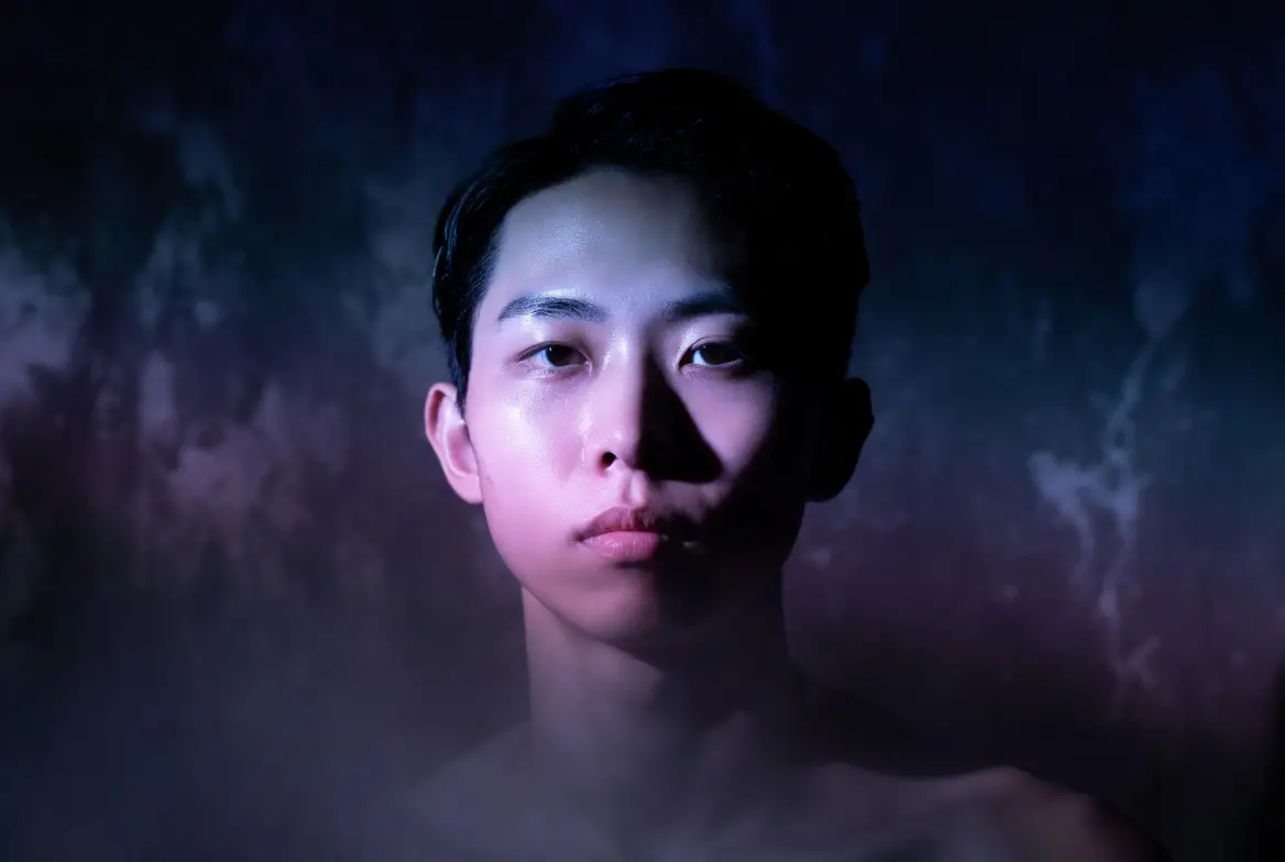 A premium album-cover portrait with controlled lighting and a moody centered composition.